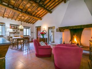 un soggiorno con sedie rosa e camino di Holiday Home Il Laghetto by Interhome a Pergine Valdarno