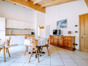 a kitchen with a table and chairs in a room at Apartment Pederiva - SOF743 by Interhome in Soraga