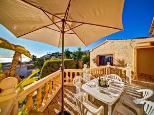 a patio with a table and chairs and an umbrella at Apartment Canuta Baja 2 by Interhome in La Canuta