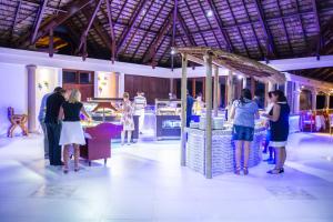 people standing around a buffet table at Le Domaine de La Reserve in Baie Sainte Anne