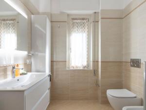 a bathroom with a toilet and a sink and a shower at Apartment Casa 51 by Interhome in Erli