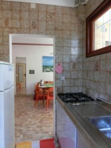 a kitchen with a sink and a stove top oven at Three-Bedroom Villa with garden, parking and ac in Bibione