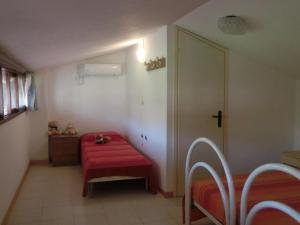 a small room with a red bench and a door at Three-Bedroom Villa with garden, parking and ac in Bibione
