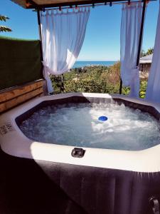 a jacuzzi tub with a view of the ocean at Annas Glamping in Batumi