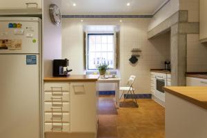 a kitchen with a refrigerator and a counter top at ALTIDO Borgia Lapa Apartments in Lisbon