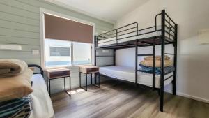 a bunk bed room with two bunk beds and a desk at Moonta Bay Holiday Park in Port Moonta +43 photos