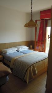 a bedroom with a large bed with blue sheets at Nice apartment in a residence with swimming pool in Bibione