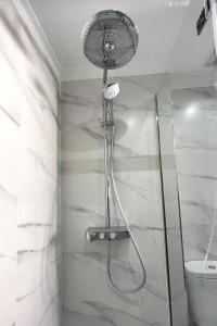 a shower with a shower head in a bathroom at Acapulco playa Nerja 407 planta superior in Nerja