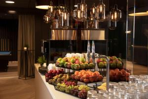 a display of fruits and vegetables in baskets on a table at Park Inn by Radisson Oslo Airport Hotel West in Gardermoen