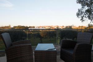 a patio with chairs and a table with a view at Casas do Regato in Castelo Branco