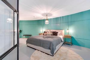 1 dormitorio con cama y pared azul en Hotel Watertoren West, en Groninga