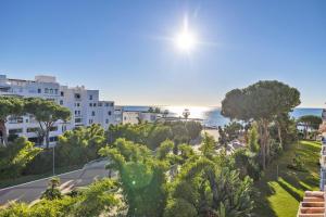 Blick auf eine Straße mit Bäumen und das Meer in der Unterkunft Confortable estudio en medina garden ref 332 in Marbella