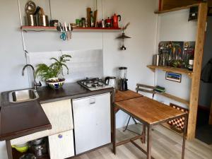 a kitchen with a counter and a sink and a table at Micro House (Back to Nature) in La Oliva