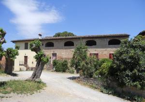 a stone building with a tree in front of it at Casa Badia in Badia