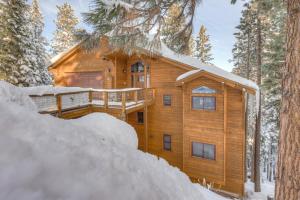 a log cabin in the woods in the snow at Windsor Lodge in Truckee