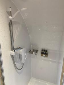 a shower with a shower head and a shower at Meall Ard Self Catering Pod - Isle of South Uist in Pollachar