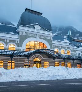 a large building with snow in front of it at Canfranc Estación, a Royal Hideaway Hotel - Gran Lujo in Canfranc-Estación