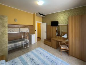 a bedroom with two bunk beds and a television at La Lanterna in Silvi Marina