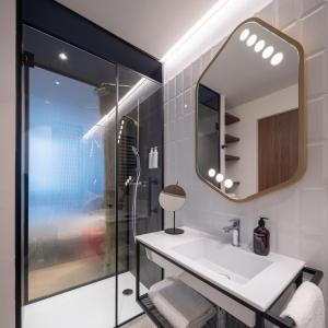 a bathroom with a sink and a mirror at Urban Hive Milano in Milan