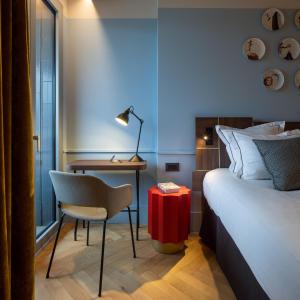 a hotel room with a bed and a desk and a chair at Urban Hive Milano in Milan