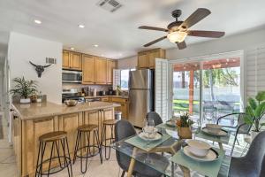 a kitchen and dining room with a ceiling fan at Palm Desert Vacation Rental with Pool Access! in Palm Desert