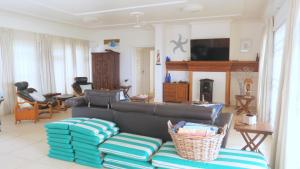 a living room with a couch and a tv at The View in Port Alfred