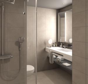 a bathroom with a shower and a sink and a toilet at Crowne Plaza - Marseille Le Dôme in Marseille