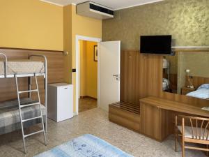 a bedroom with a bunk bed and a desk with a television at La Lanterna in Silvi Marina