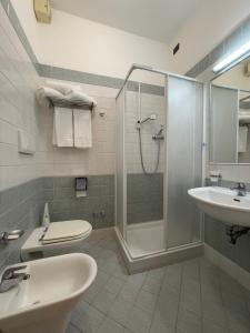 a bathroom with a shower and a toilet and a sink at La Lanterna in Silvi Marina