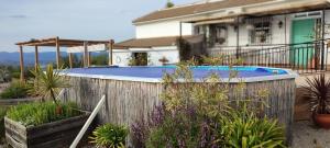 a swimming pool in the backyard of a house at New Leaf Cortijo Apartment ,Moclin in Moclín