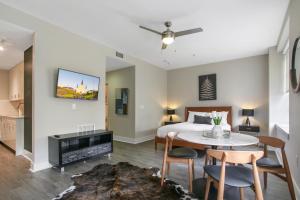 a bedroom with a bed and a table and chairs at Pet-Friendly Spacious condos in Downtown New Orleans in New Orleans