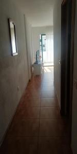 a hallway with a room with a table and a window at costa del silencio 1 in Costa Del Silencio +17 photos
