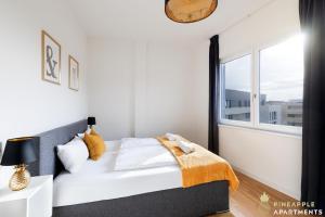 a bedroom with a bed and a large window at Pineapple Apartments Penthouse am Zwinger - 162 qm - 1x free parking in Dresden