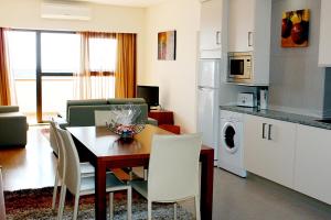 a kitchen and dining room with a table and chairs at Solmar Alojamentos in Ponta Delgada