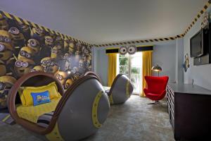 a childs bedroom with a bed in a room with a wall covered in eyes at Universal's Loews Portofino Bay Hotel in Orlando