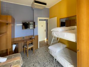 a room with two bunk beds and a desk at La Lanterna in Silvi Marina