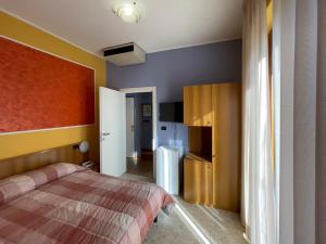 a bedroom with a bed and a refrigerator at La Lanterna in Silvi Marina