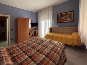 a hotel room with a bed and a window at La Lanterna in Silvi Marina