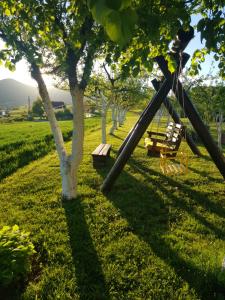 a park with a swing and a tree at Apartment Rosandić in Smoljanac