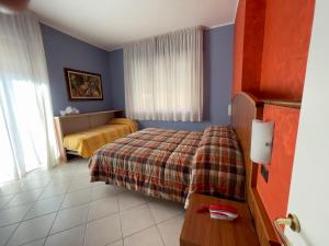 a hotel room with a bed and a window at La Lanterna in Silvi Marina