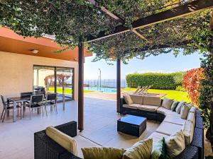 een patio met banken en een tafel en stoelen bij Villa Vitoria Dos in Câmara de Lobos