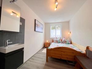 a small bedroom with a bed and a sink at Apartment Moser by Interhome in Stein an der Enns