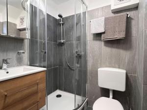 a bathroom with a shower and a toilet and a sink at Apartment Moser by Interhome in Stein an der Enns