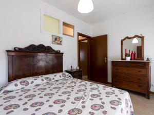 a bedroom with a bed and a dresser and a mirror at Apartment Casa dalla Mamma by Interhome in Montalto Ligure