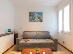 a living room with a couch and a table at Apartment Casa dalla Mamma by Interhome in Montalto Ligure