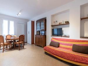 a living room with a bed and a dining room at Apartment Casa dalla Mamma by Interhome in Montalto Ligure