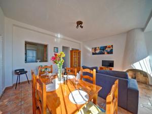 a living room with a table and a blue couch at Apartment Canuta Baja-6 by Interhome in La Canuta