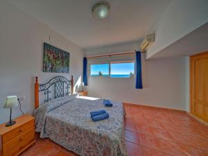 a bedroom with a bed and a window at Apartment Canuta Baja-8 by Interhome in La Canuta