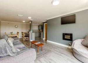 a living room with a couch and a fireplace at Sandy Park in Trimdon