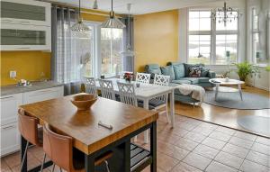 a kitchen and living room with a couch and a table at Awesome Home In Ronneby With Kitchen in Ronneby